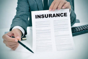 Man showing an insurance paper in California.