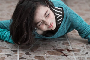 Injured woman lying on the floor after a slip and fall in Santa Rosa.