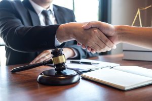 An attorney giving his client a handshake after winning his case.