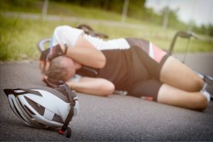 Cyclist lying on her side after an accident.